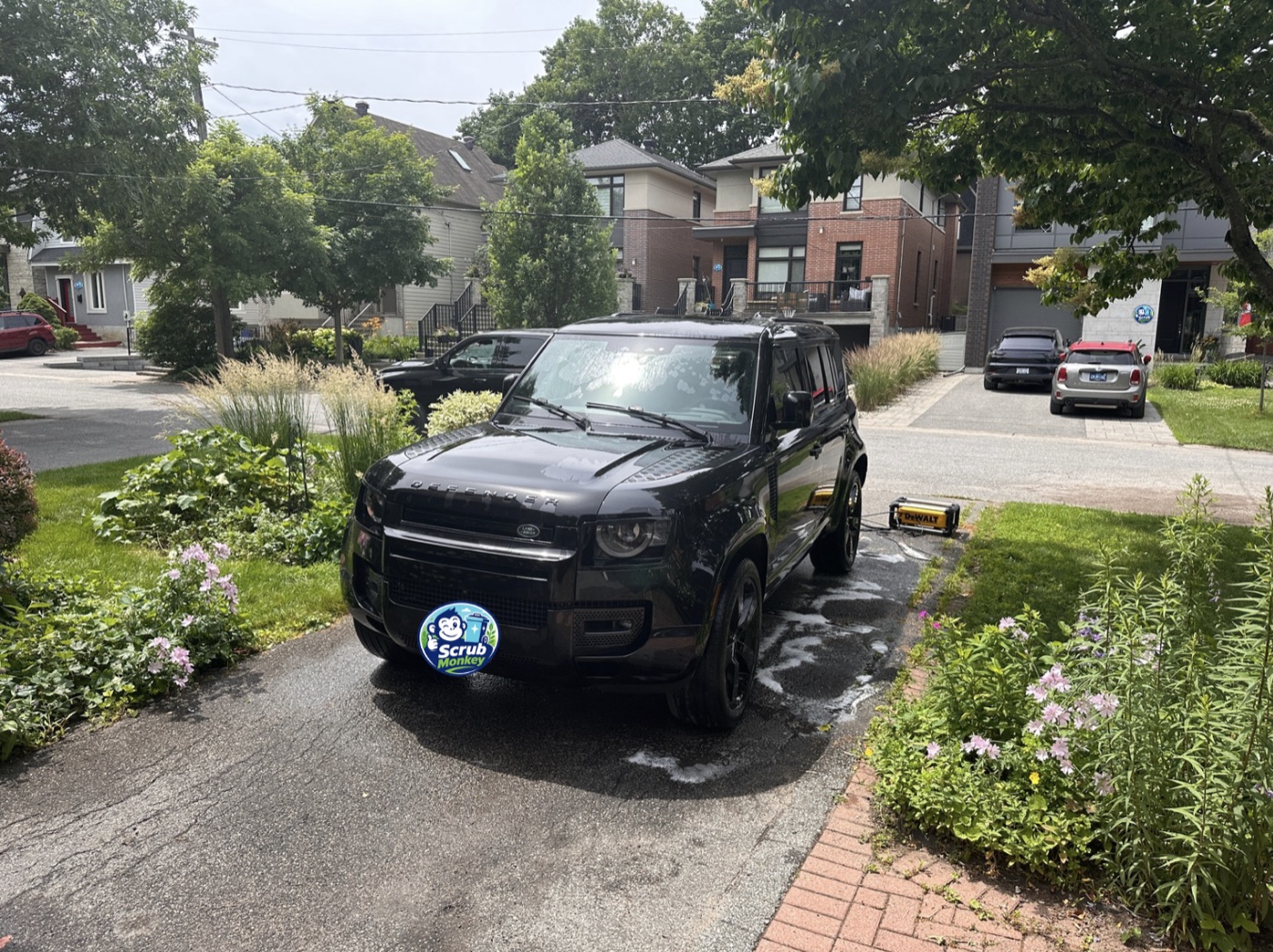ScrubMonkey washing a car in an Ottawa driveway
